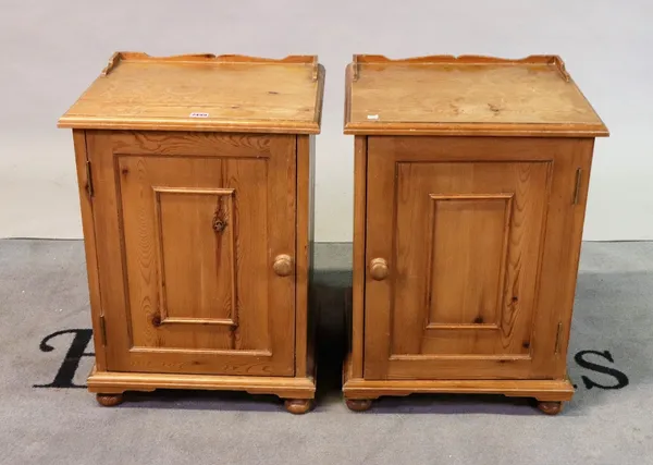 A pair of modern pine bedside cupboards