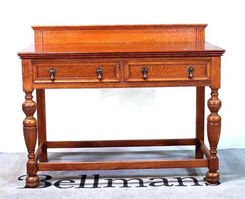 A 20th century two drawer oak side table