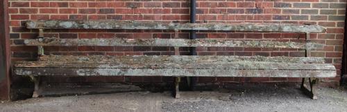 A early 20th century garden bench on three cast iron supports