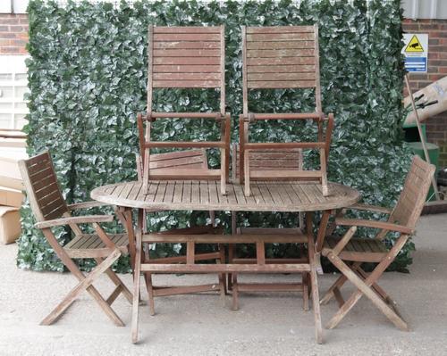 A modern hardwood oval folding garden table, 149cm wide; 75cm high