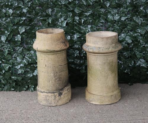 A similar pair of early 20th century terracotta chimney pots, 32cm diameter; 60cm high (2)
