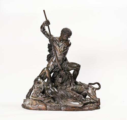 A large bronze sculpture of a Nubian defending his family against a lion