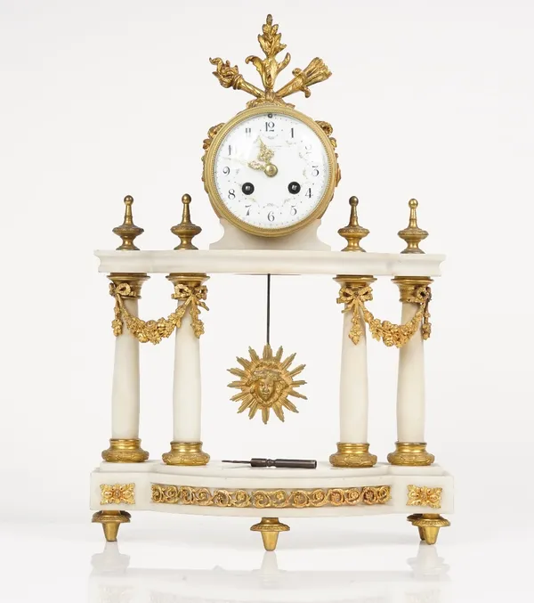 An Empire style ormolu and white marble mantel clock