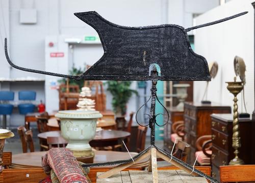 A black painted wrought and sheet iron weather vane