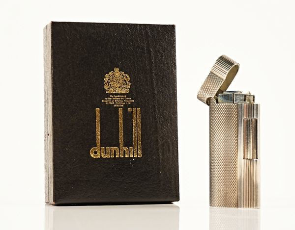 A Dunhill gas lighter, detailed tot he underside '20 MICRONS' with serial number D12935, boxed with booklets.