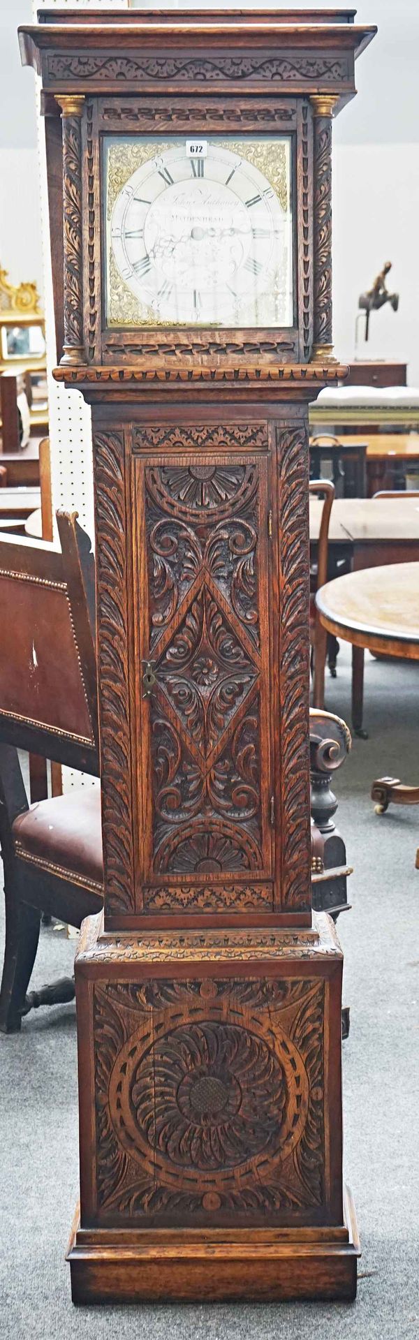 A carved oak longcase clock