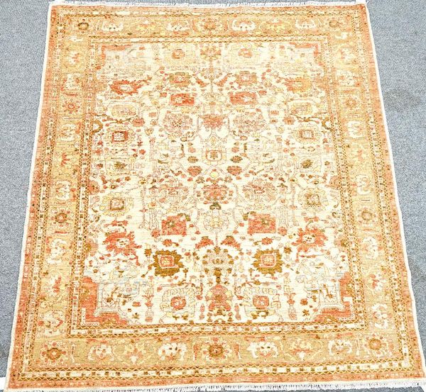 A Pakistan rug, the beige field with an allover floral design in complementary colours, 244cm x 220cm.