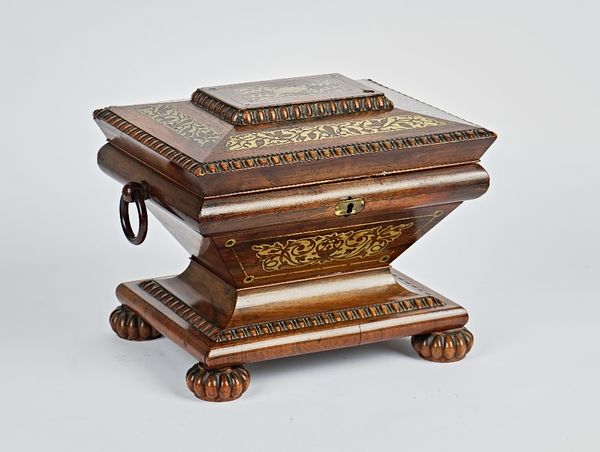 A Regency brass inlaid rosewood sewing box of exaggerated  sarcophagus form with fitted interior on carved melon feet, 28cm wide; 22cm high.