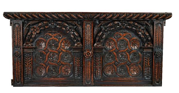 A 17th century style carved oak panel with gadrooned frieze and concentric circular decoration, 127cm wide; 58cm high