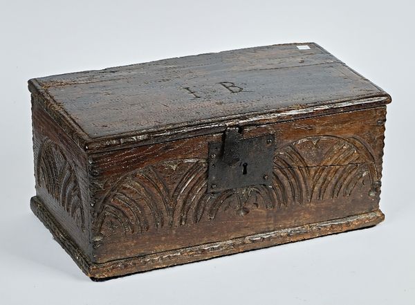 A 17th century oak box, with carved front panel, 48cm wide; 22cm high