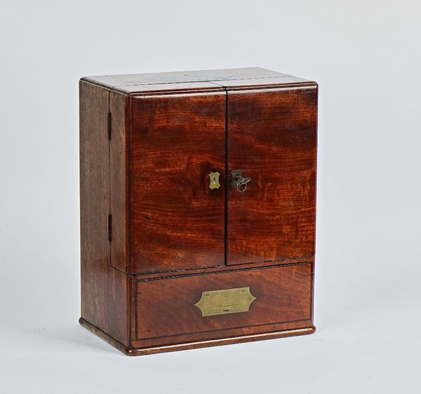 An early 19th century mahogany apothecary cabinet, with a pair of doors over drawer, both enclosing a fitted interior 30cm wide; 37cm high