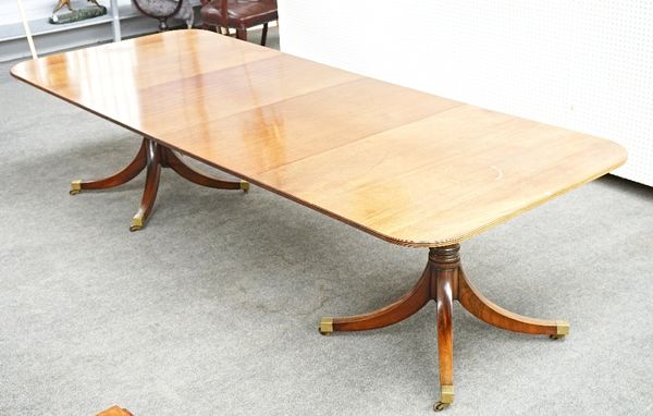 A Regency style mahogany twin pillar extending dining table, on pair of turned columns and eight downswept supports, with two extra leaves, 115cm...