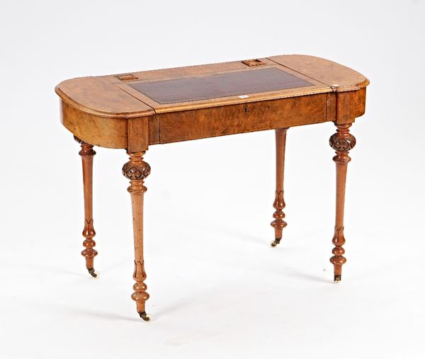 A Victorian figured walnut rounded rectangular writing desk