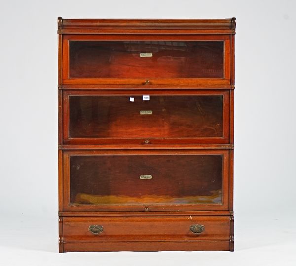 The Globe-Wernicke Co. Ltd, a mahogany glazed three section bookcase on a single drawer base, 87cm wide; 116cm high