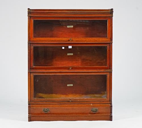 The Globe-Wernicke Co. Ltd, a mahogany glazed three section bookcase on a single drawer base, 87cm wide; 116cm high