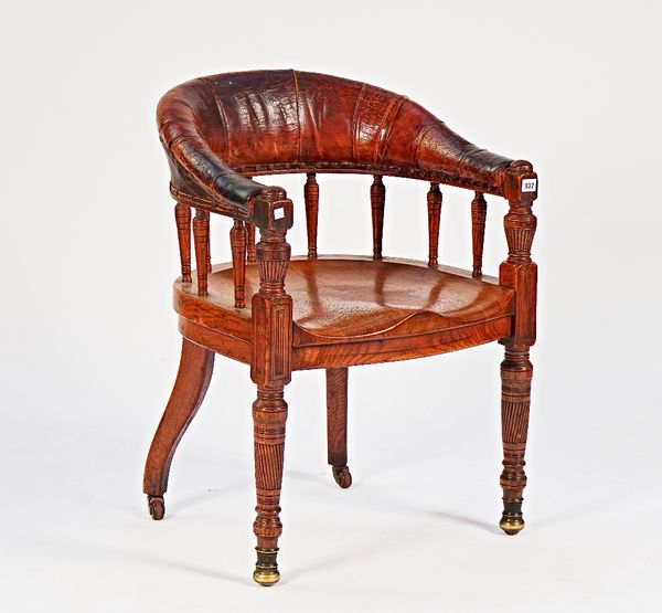 A late Victorian oak and leather upholstered tub back desk chair, on spiral fluted supports, 60cm wide; 82cm high