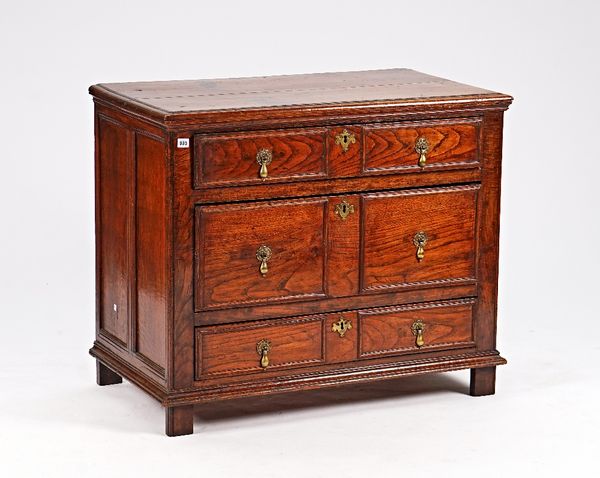 A late 17th century oak chest of three long drawers, on stile feet, 101cm wide x 85cm high.
