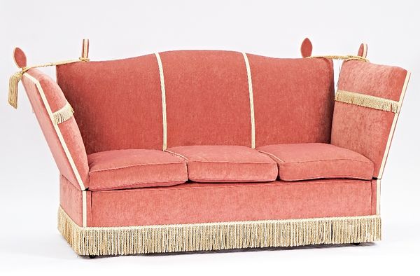 A pink upholstered hump back Knole sofa with tassel fringe, 195cm wide x 108cm high.