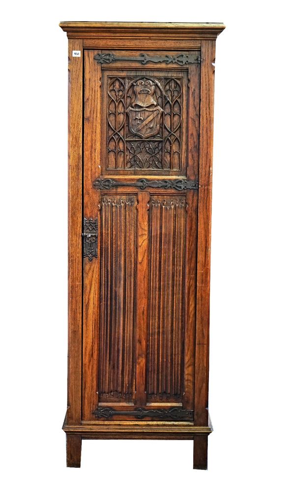 A Gothic Revival oak single door wardrobe, with carved linen fold decoration, 65cm wide x 180cm high.