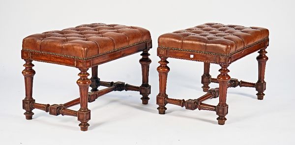 A pair of 19th century French brown button leather upholstered rectangular footstools on fluted supports, 71cm wide x 48cm high (2).