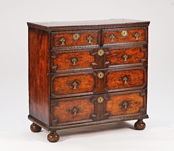 A Charles II and later yew chest of two short and three long geometric drawers, on bun feet, 106cm wide x 104cm high.
