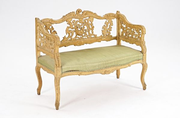 A Rococo Revival distressed painted small square back sofa with pierced decoration and serpentine seat, 105cm wide x 84cm high.