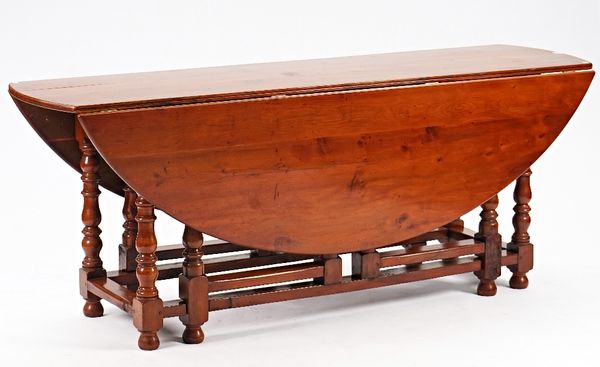 An 18th century style yew wood drop flap wake table on turned  supports, 198cm long x 153cm wide open.