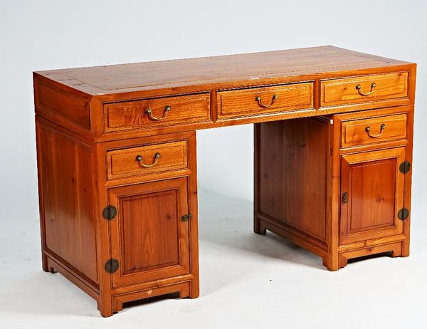 A 20th century Chinese hardwood pedestal desk with five drawers about the knee, 142cm wide x 64cm deep.