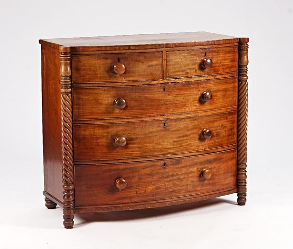 A Regency mahogany bowfront chest of two short and three long graduated drawers, flanked by spiral columns, 113cm wide x 98cm high.