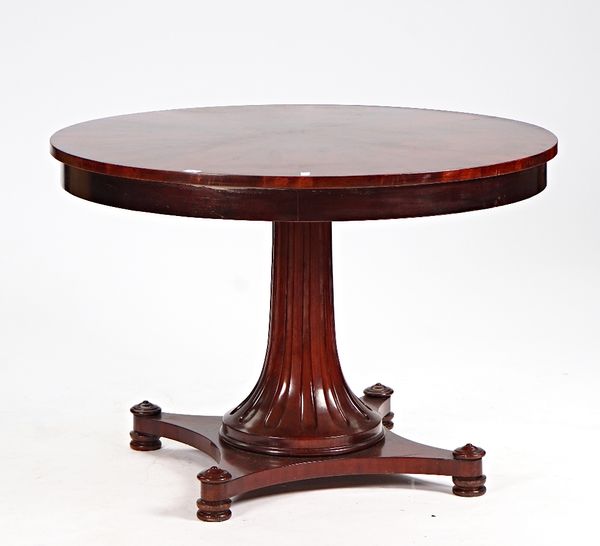 A Regency style circular stella veneered mahogany centre table, on flared fluted column, 112cm diameter x 77cm high.