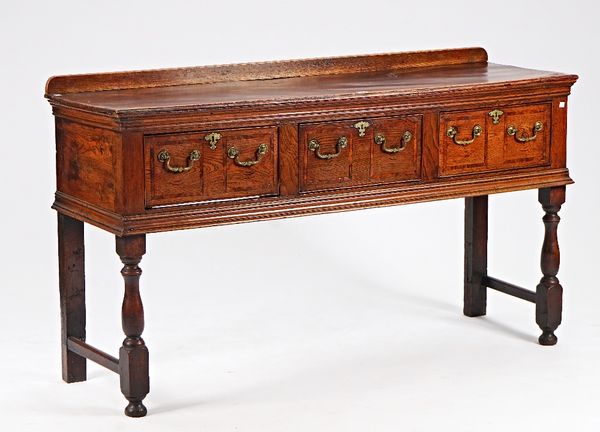 A mid-18th century oak three drawer dresser base, on baluster turned supports, 157cm wide x 90cm high.