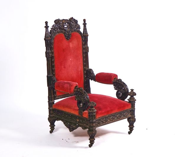 A 19TH CENTURY CONTINENTAL EXTENSIVELY CARVED GOTHIC REVIVAL OPEN ARMCHAIR