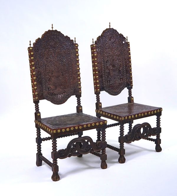 A PAIR OF 17TH CENTURY STYLE SPANISH STUDDED AND EMBOSSED LEATHER HIGHBACK SIDE CHAIRS