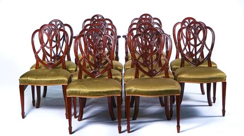 A SET OF TWELVE HEPPLEWHITE STYLE MAHOGANY DINING CHAIRS