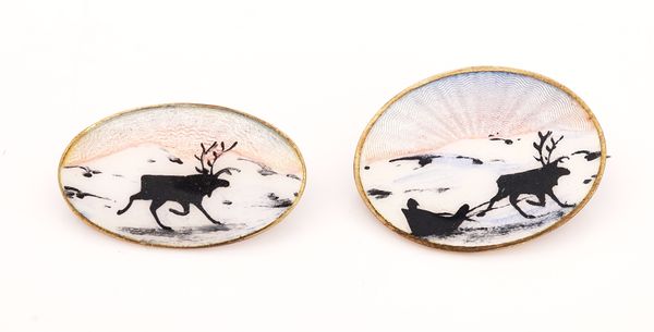 TWO SCANDINAVIAN SILVER GILT AND ENAMELLED OVAL BROOCHES