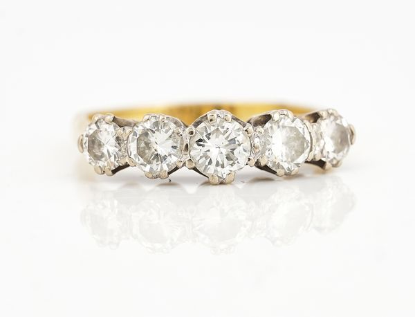 A GOLD AND DIAMOND FIVE STONE RING