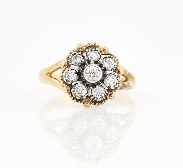 A GOLD AND DIAMOND EIGHT STONE CLUSTER RING
