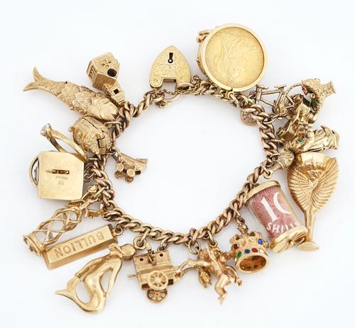 A 9CT GOLD CURB LINK CHARM BRACELET