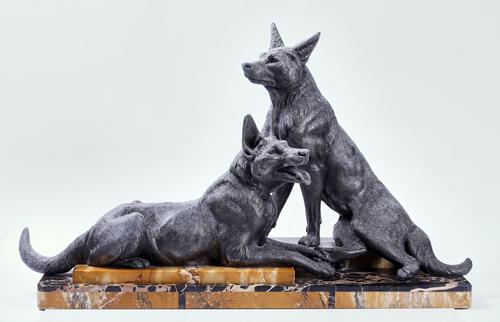 AN ART DECO SPELTER AND MARBLE MOUNTED SCULPTURE OF TWO GERMAN SHEPHERDS