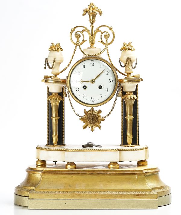 A FRENCH GILT-METAL AND WHITE MARBLE MANTEL CLOCK