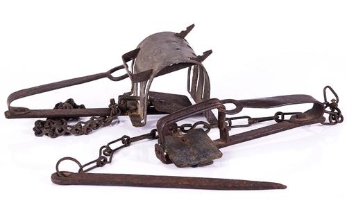 A WROUGHT IRON GIN TRAP AND A TUNNEL TRAP (2)