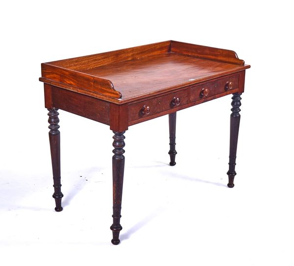 A REGENCY MAHOGANY GALLERIED TWO DRAWER WRITING TABLE