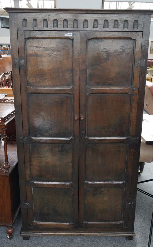 AN EARLY 20TH CENTURY STAINED OAK EIGHT PANEL HALL CUPBOARD