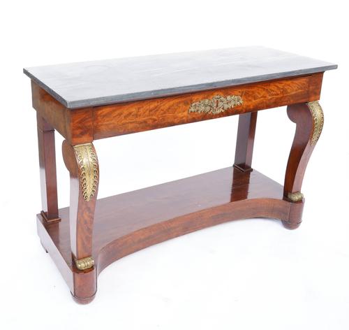 AN EARLY 19TH CENTURY FRENCH MARLE TOPPED GILT METAL MOUNTED MAHOGANY SINGLE DRAWER CONSOLE TABLE