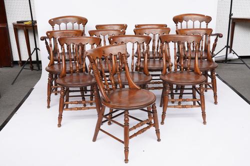 A SET OF TWELVE EARLY 20TH CENTURY STAINED BEECH SPINDLE BACK DINING CHAIRS (12)