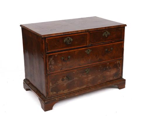 A GEORGE II FIGURED WALNUT CHEST OF DRAWERS