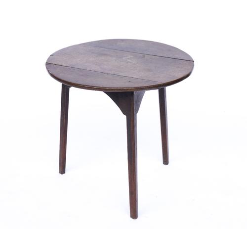 A GEORGE III OAK CRICKET TABLE ON CANTED SQUARE SUPPORTS
