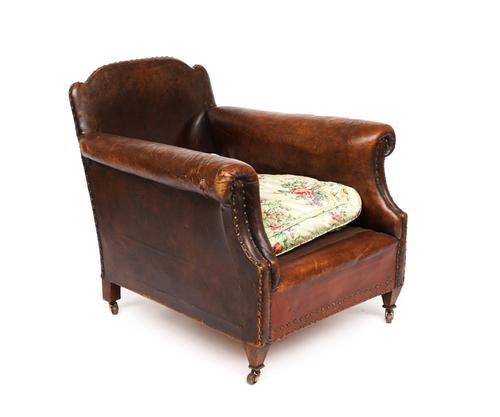 AN EARLY 20TH CENTURY STUDED TAN LEATHER UPHOLSTERED EASY ARMCHAIR