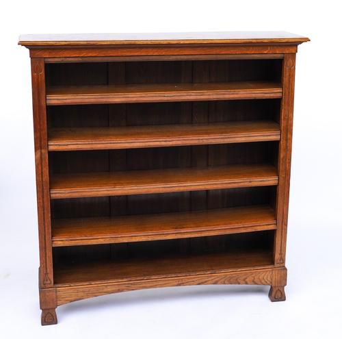 IN THE MANNER OF LIBERTYS; AN ART NOUVEAU FLOOR STANDING OAK OPEN FIVE TIER BOOKCASE