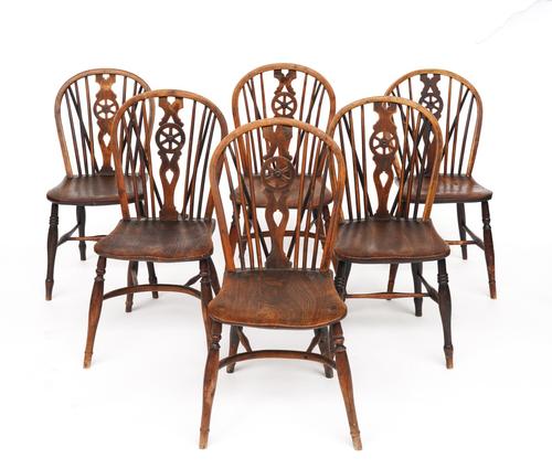 A MATCHED SET OF SIX YEW AND ASH ELM SEATED WHEELBACK CHAIRS (6)
